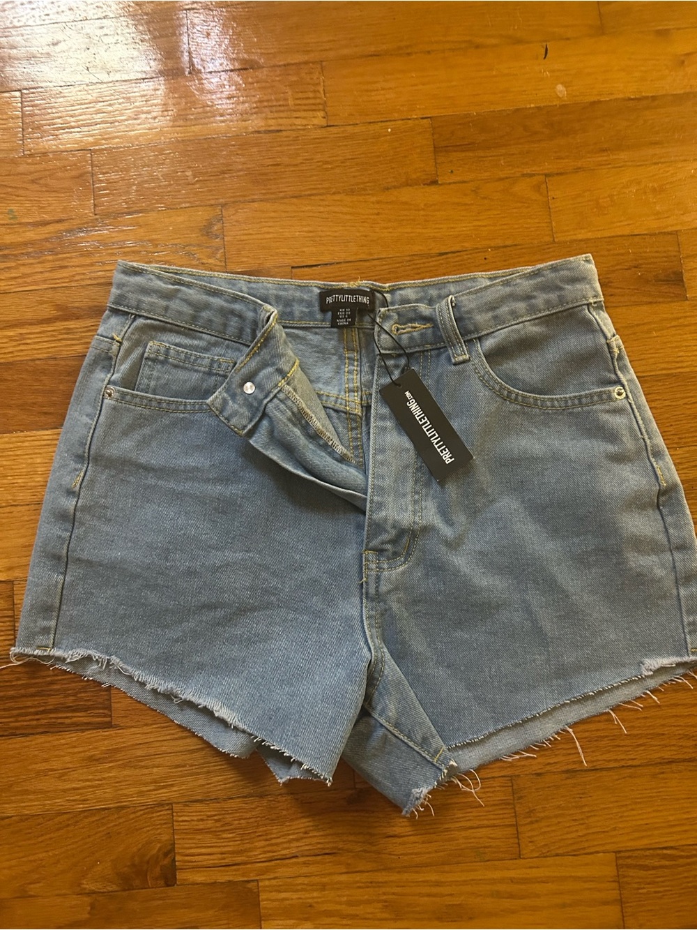 PrettyLittleThing Light Blue Denim High Rise Raw Hem Shorts